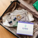 open, packed suitcase with sunglasses, clothes and sync pack box, Buy Supplements Online in Baton Rouge for Easy At-Home Wellness