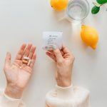 woman holding sync immune pack, 3 Essential Wellness Vitamins You Need During Winter