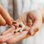 hands holding 5 supplements, 3 Reasons to Order Vitamins