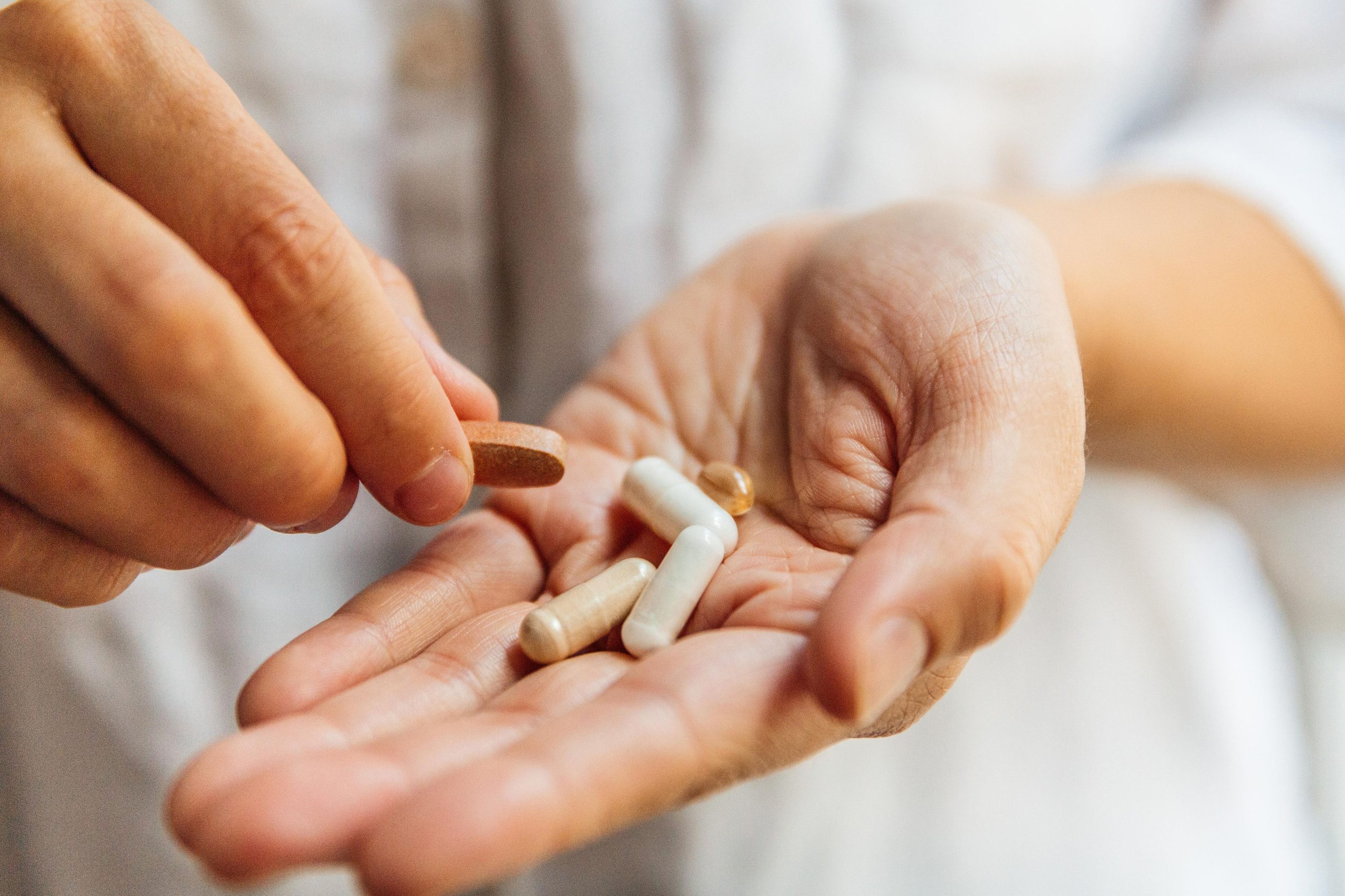 hands holding 5 supplements, 3 Reasons to Order Vitamins