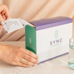 box of personalized sync packs with hands and glass of water, 5 Advantages of Professional-Grade Nutritional Supplementation